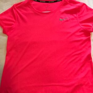 Bright pink neon Nike shirt.